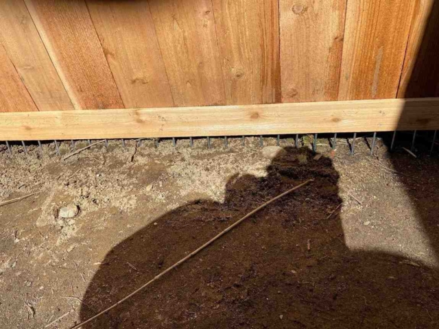 Wood Fence Base with Ground Gap and Metal Grading Rods Installation