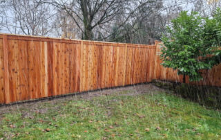 Rain-soaked wooden fence, showcasing a horizontal-style fence in Greater Seattle, WA.