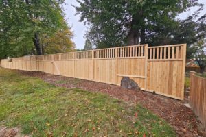 A wooden fence and post, exemplifying cedar fence styles found in Greater Seattle and the Eastside